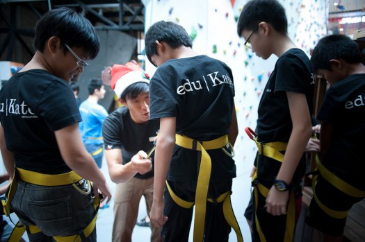 last check before we head out- eduKate Students gets final safety check by Climb Central Staff. Learning a new skill, equipment and peripheral in a short amount of time is the lesson here.